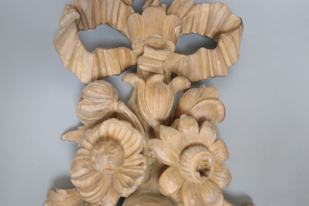 A carved beech ribbon and fruit wall applique, length 47cm